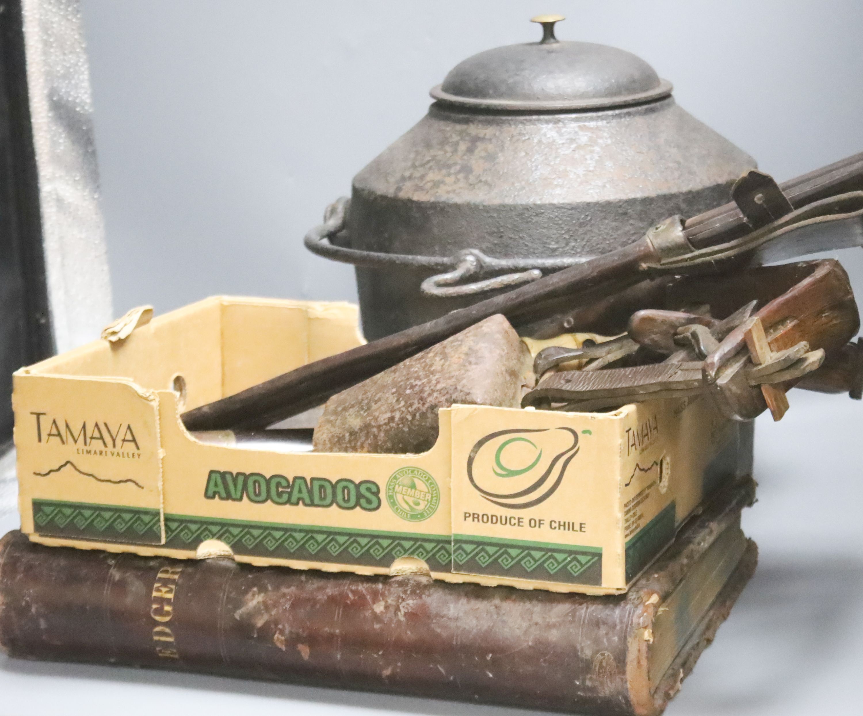 A 19th century tooth extractor, boot pulls, military knives, telescope, leather ledger and iron kettle